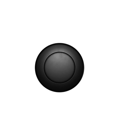 The Custom Drain Cap Finish is a sleek, black, circular device featuring a minimalist design set against a black background. It boasts a central button-like element encircled by a subtly raised outer ring.