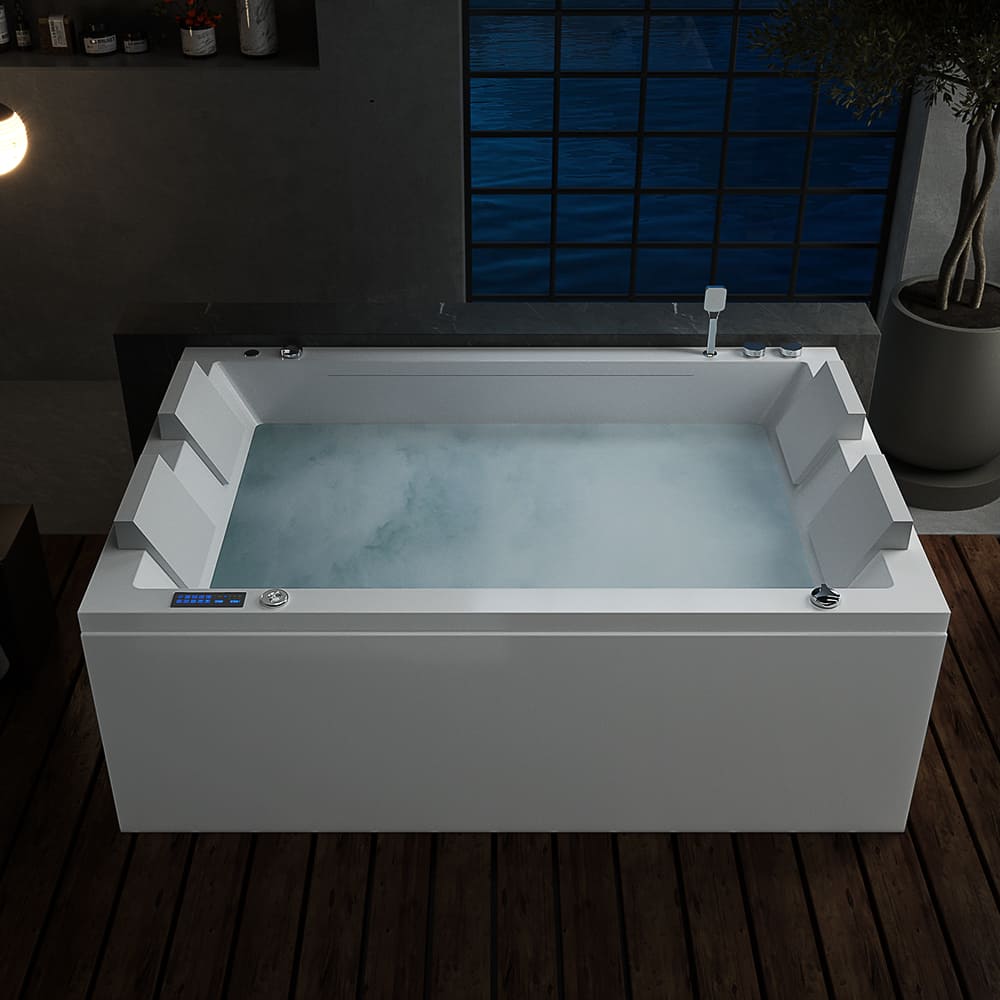 A modern white 71 in. Freestanding Combination Massage 2-Person LED Tub with Center Drain by Empava, filled with water and light bubbles, stands in a dimly lit bathroom with dark walls and a wooden floor. The tub features built-in armrests and a sleek digital control panel on its side, perfect for enjoying Revi-Skin Therapy. Nearby, a large window and potted plant are visible.