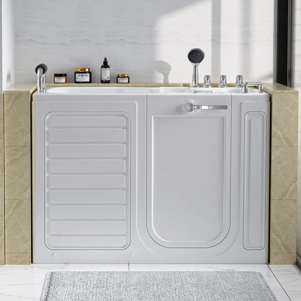 A 54" Alcove Soaking Walk-in Tub with Right Drain, featuring a front-facing door, is installed in a bathroom with beige tile flooring and walls. The bathtub includes a hand-held showerhead and faucet. Various bath products are arranged on the ledge behind the tub, and a gray bath mat is laid out on the floor.