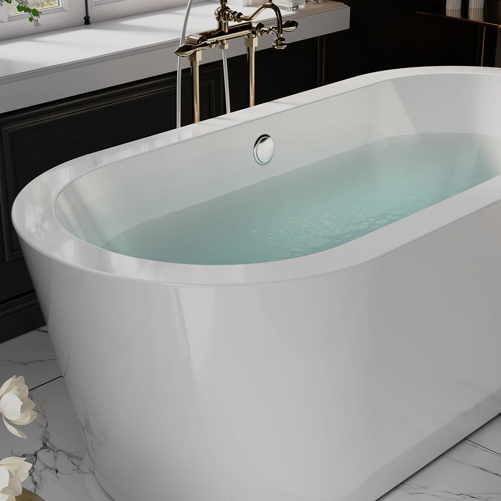 The 59" Freestanding Soaking Tub with Center Drain, featuring a modern white oval design and acrylic material, is filled with water and sits in a stylish bathroom with marble flooring. The bathtub comes equipped with a chrome tap and an attached handheld shower head. In the background, part of a white sink and dark cabinetry can be seen.