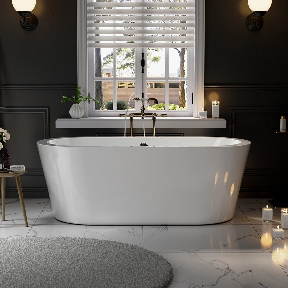 A modern bathroom with an oval design showcasing a 59" Freestanding Soaking Tub with Center Drain in pristine white, positioned in front of a large window adorned with white blinds. The room features dark walls and marble floors, softly illuminated by candles and wall sconces. A round, gray rug adorns the floor, while plants and decorative items sit on a small table nearby.