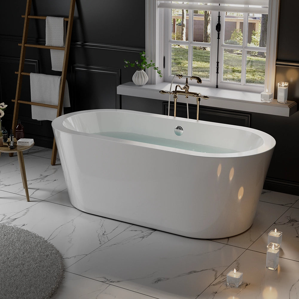 A luxurious bathroom featuring the 59" Freestanding Soaking Tub with Center Drain, filled with water. The room has a dark-paneled wall and a large window offering a view of the garden. Candles, a wooden towel ladder, and potted plants enhance the serene ambiance. The floor is tiled in white marble.