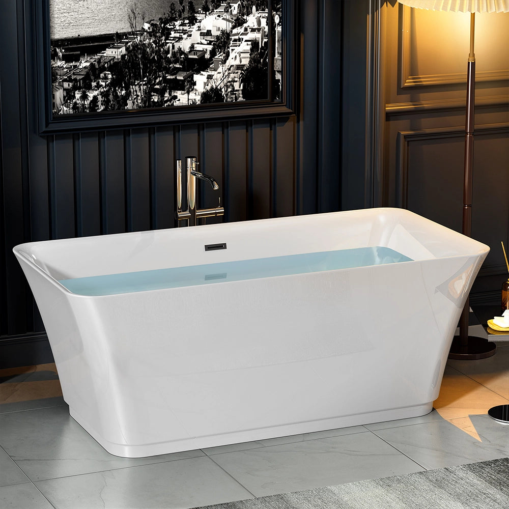 The 59" Freestanding Soaking Tub with Center Drain, crafted from lightweight acrylic material, graces a stylish bathroom with dark paneled walls. A floor lamp stands beside this modern rectangular white bathtub, while a black-and-white cityscape picture hangs above the freestanding installation. The floor is adorned with large gray tiles.