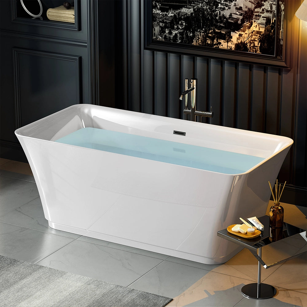 A sleek white 59" Freestanding Soaking Tub with Center Drain filled with water stands in a dark, modern bathroom. Marble floor tiles and dark wall panels enhance the space. Nearby is a small table with bottles and a towel, adding to the luxurious ambiance.