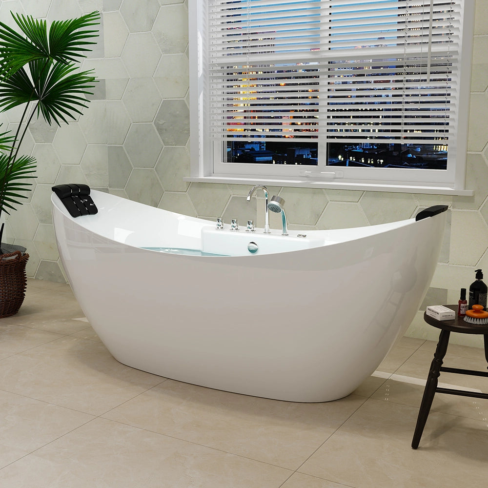 A modern bathroom with a white 67" freestanding boat-shaped whirlpool bathtub with a center drain on a beige tile floor. The bath features sleek chrome fixtures and black headrests. A large window with horizontal blinds overlooks a cityscape. A potted plant and a small side table with toiletries are nearby, creating a serene space that's as stylish as it is crack-resistant.