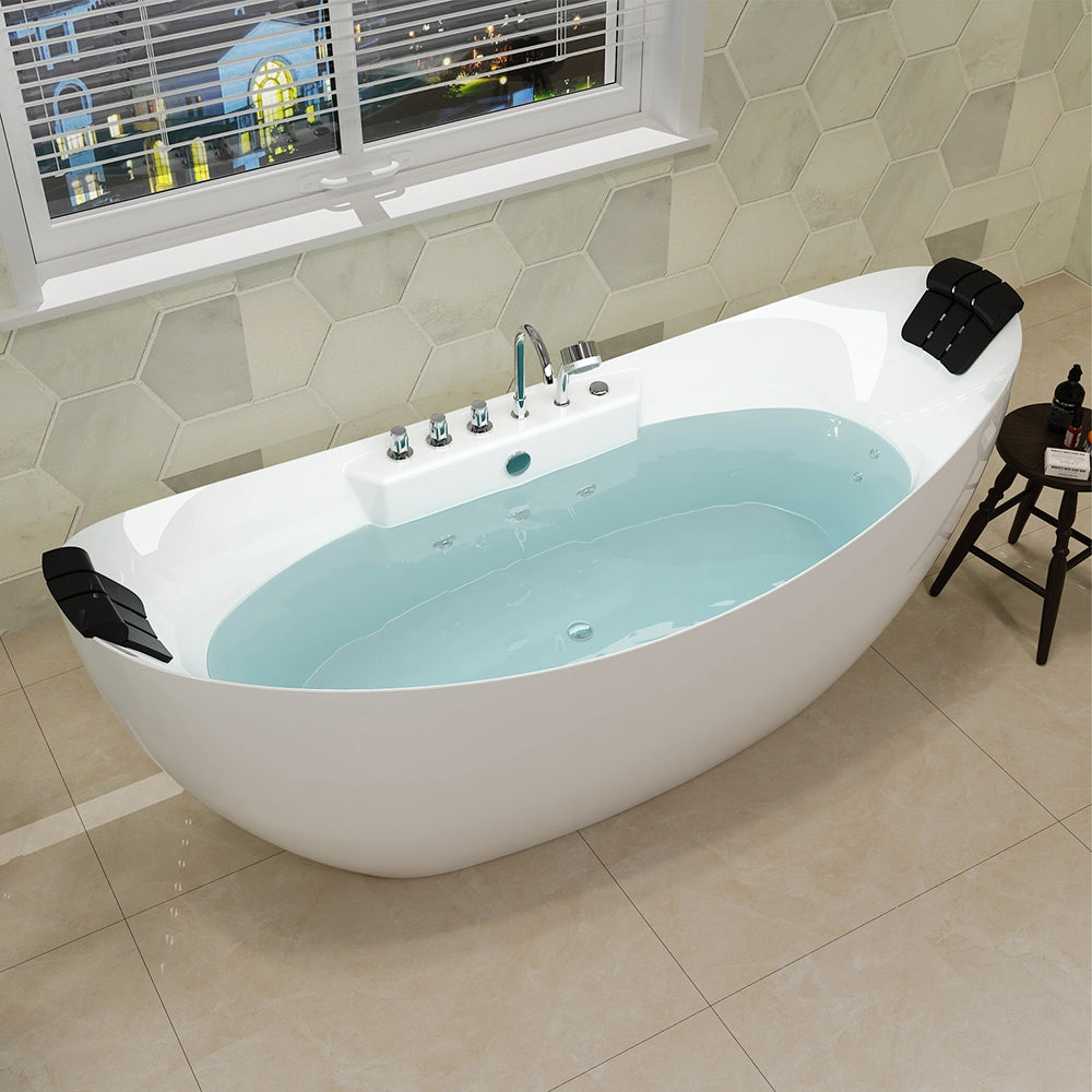 A modern bathroom showcasing a 67" Freestanding Boat-shaped Whirlpool Bathtub with Center Drain, filled with water. The crack/mold-resistant bathtub features black headrests on both ends and a central faucet with controls. Behind it is a wall adorned with hexagonal tiles, while a window with venetian blinds is visible above. A small wooden stool sits beside the tub.