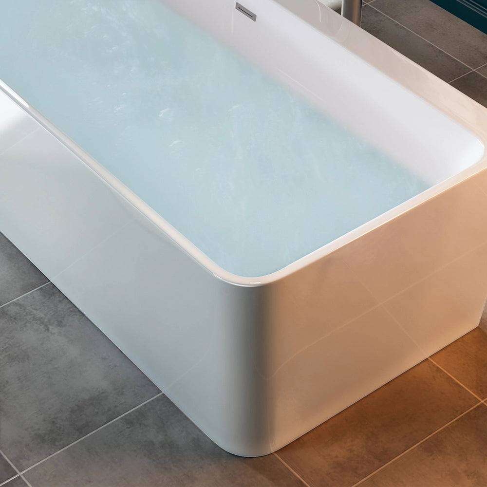 A 67" Freestanding Soaking Tub with Center Drain, featuring a modern design in white acrylic, fills with clear water in a bathroom adorned with gray tiled flooring. One corner of the tub is visible, highlighting its sleek, ergonomic contours and ambient lighting. The water appears calm and inviting.