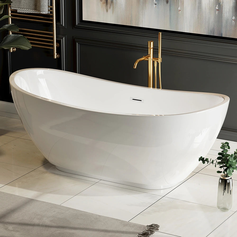 A modern bathroom showcases the 69" Freestanding Soaking Tub with Center Drain, featuring a sleek, white design with elegant curves for ergonomic soaking, positioned on a shiny white-tiled floor. Beside the tub is a potted green plant, and a gold-tone floor-mounted faucet adds a luxurious touch. The wall is dark and stylishly decorated.