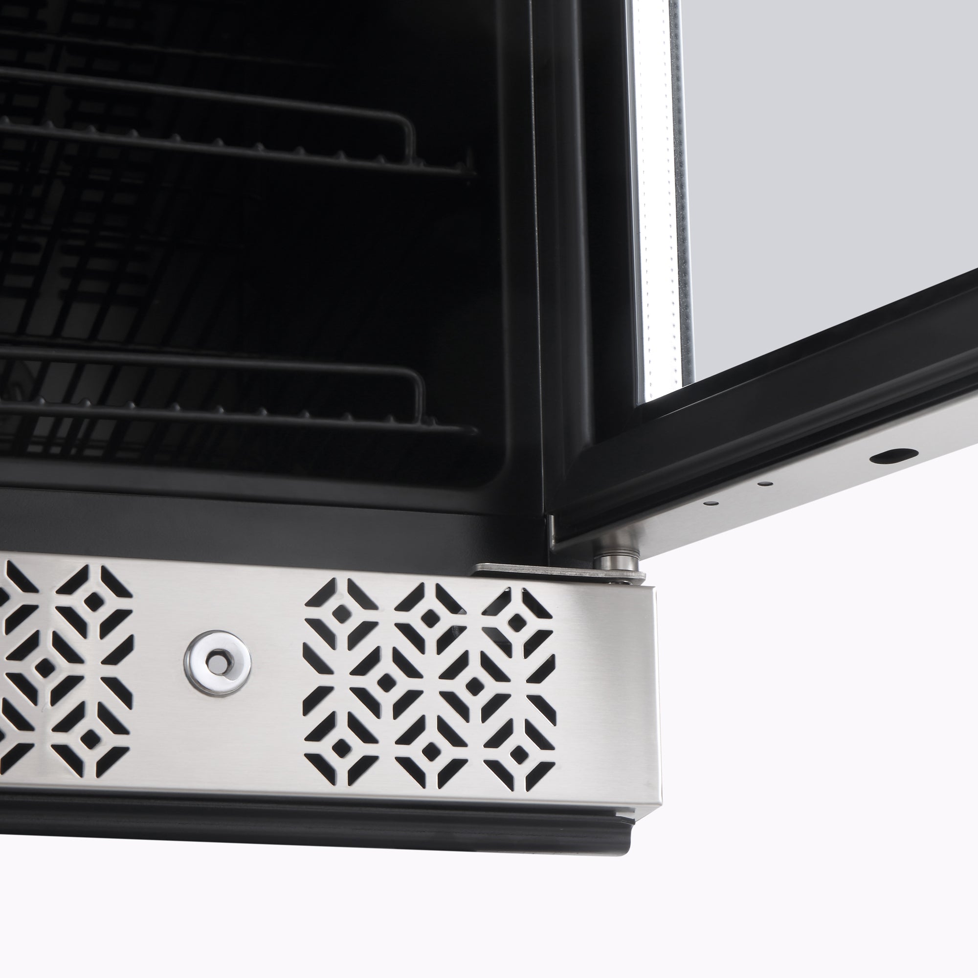 A close-up image of the corner of an open Empava 24" Dual Zone Wine and Beer Fridge Beverage Cooler door reveals a stainless steel edge with a geometric, lattice-like vent pattern. Inside, wire shelves are visible. The minimal and modern surroundings enhance the sleek, contemporary design of the Empava appliance.