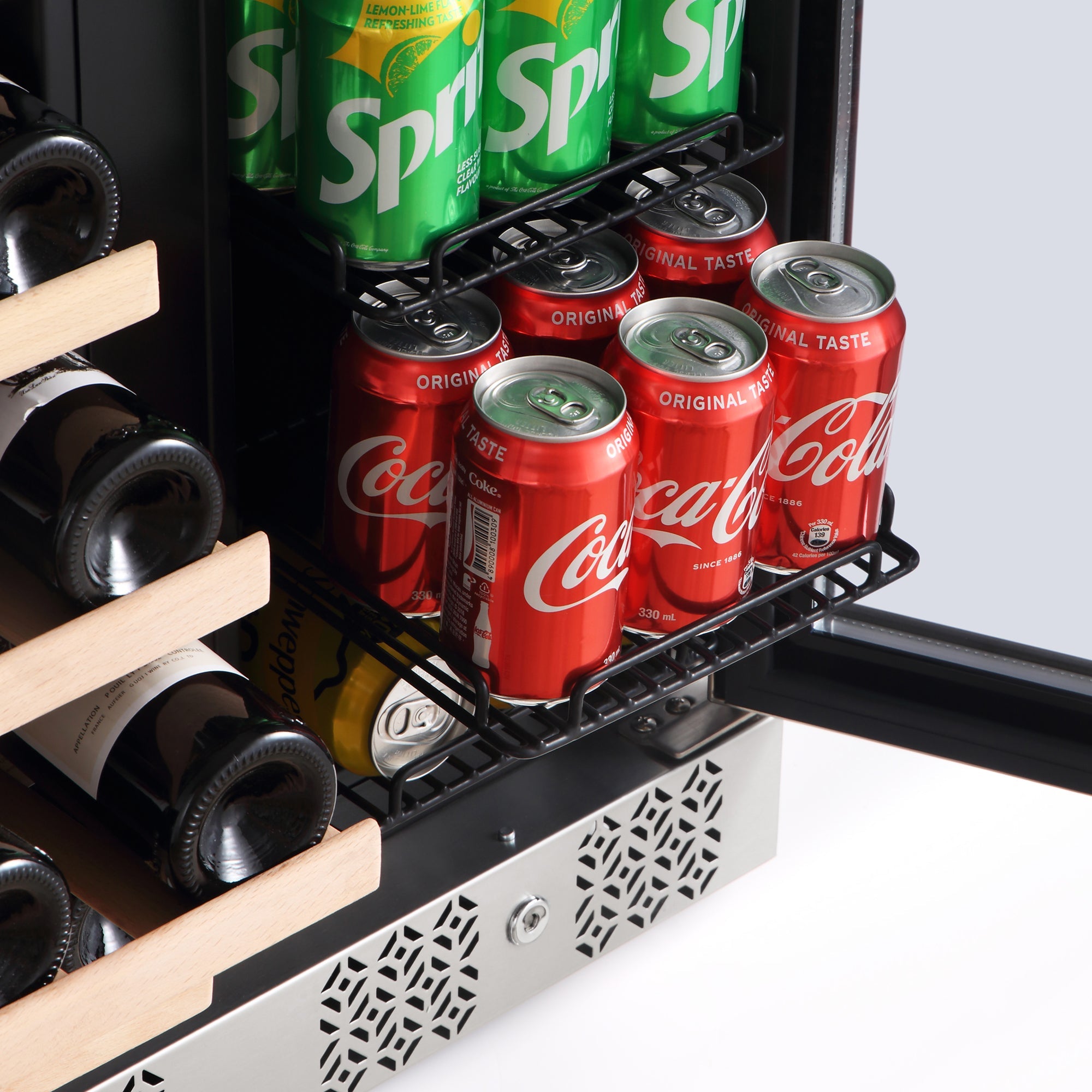 The Empava 24" Dual Zone Wine and Beer Fridge Beverage Cooler showcases its shelves stocked with Sprite and Coca-Cola cans. One shelf is extended, displaying two rows of Coca-Cola cans, while wooden racks store several wine bottles. The open fridge door reveals a variety of beverages.