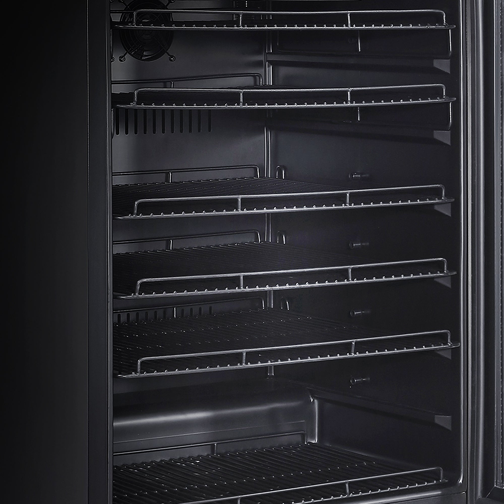 The Empava 24 Inch Freestanding & Under Counter Beverage Fridge boasts a sleek black interior, featuring multiple evenly spaced metal racks. The sides and back have ventilation slits, and a fan is visible at the top. The door is partially open, revealing the spacious inside.