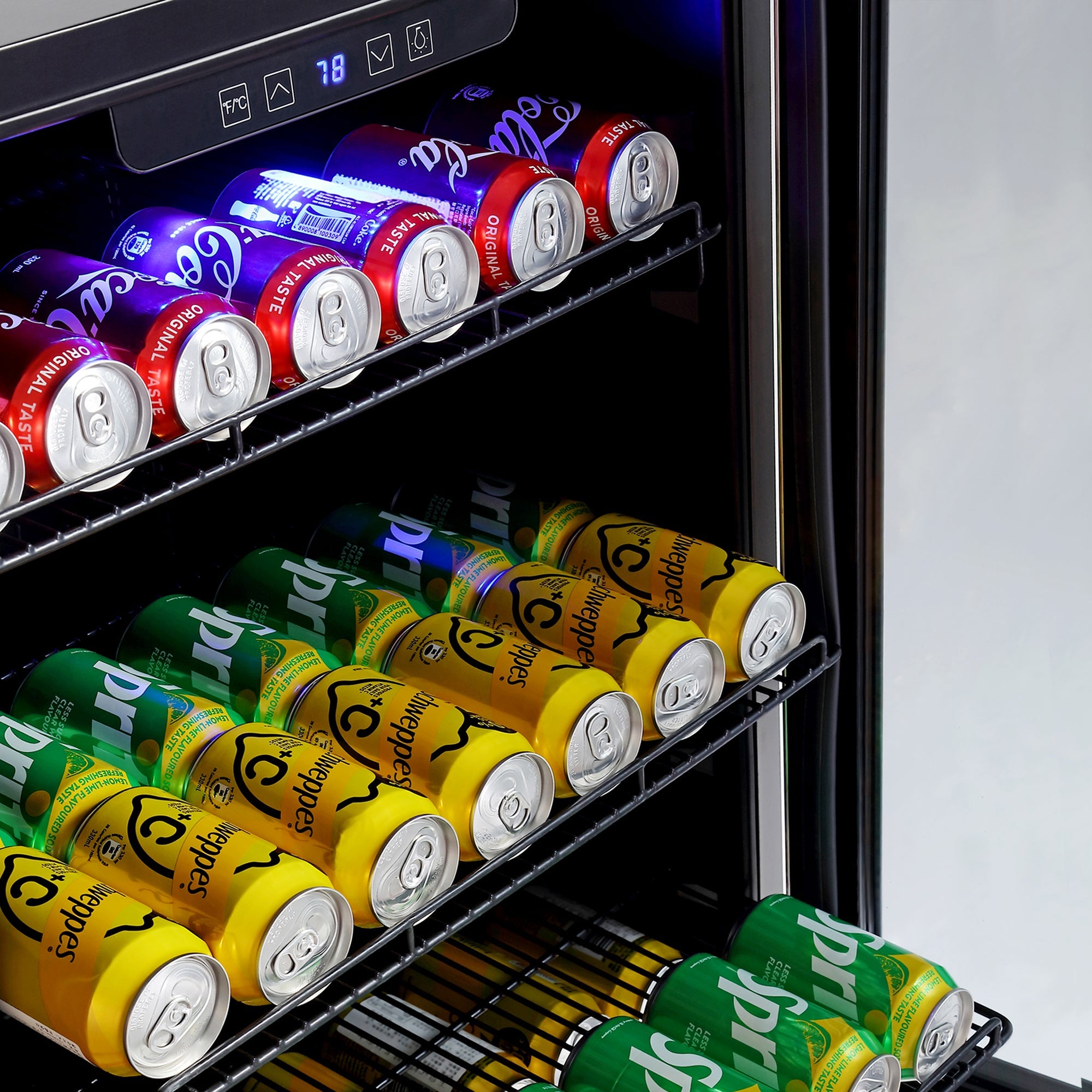 The Empava 24 Inch Freestanding & Under Counter Beverage Fridge is stocked with an assortment of soda cans. The top shelf features red cans, the second shelf holds both yellow and green cans, and the third shelf is exclusively for yellow cans. The digital temperature display at the top reads "78.