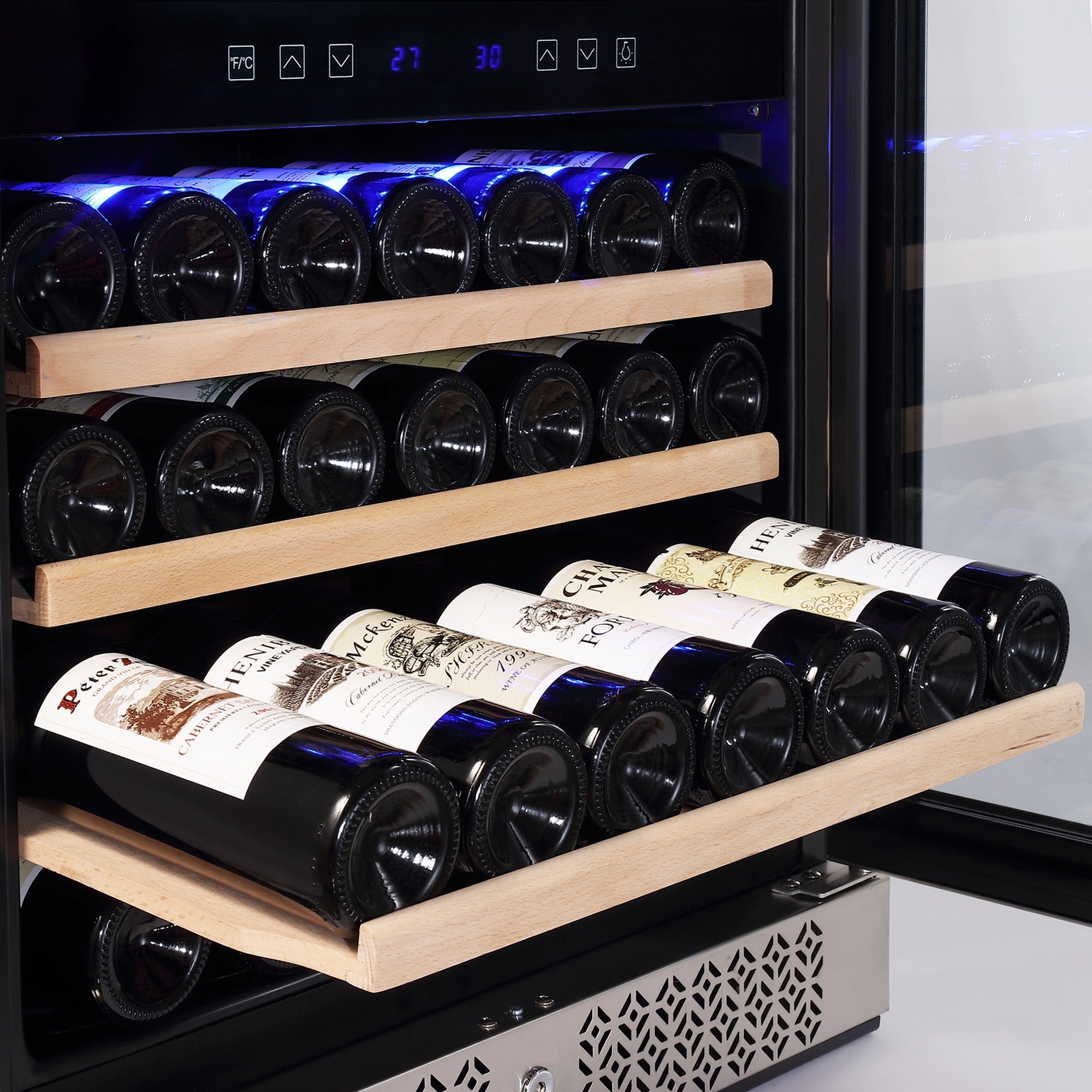 The Empava 24 Inch Dual Zone Wine & Beverage Cooler with its door open showcases three wooden racks filled with wine bottles, neatly arranged in two rows per rack with their labels facing out. The fridge's interior is illuminated by a blue light, highlighting the well-organized storage, while the control panel is clearly visible at the top front.