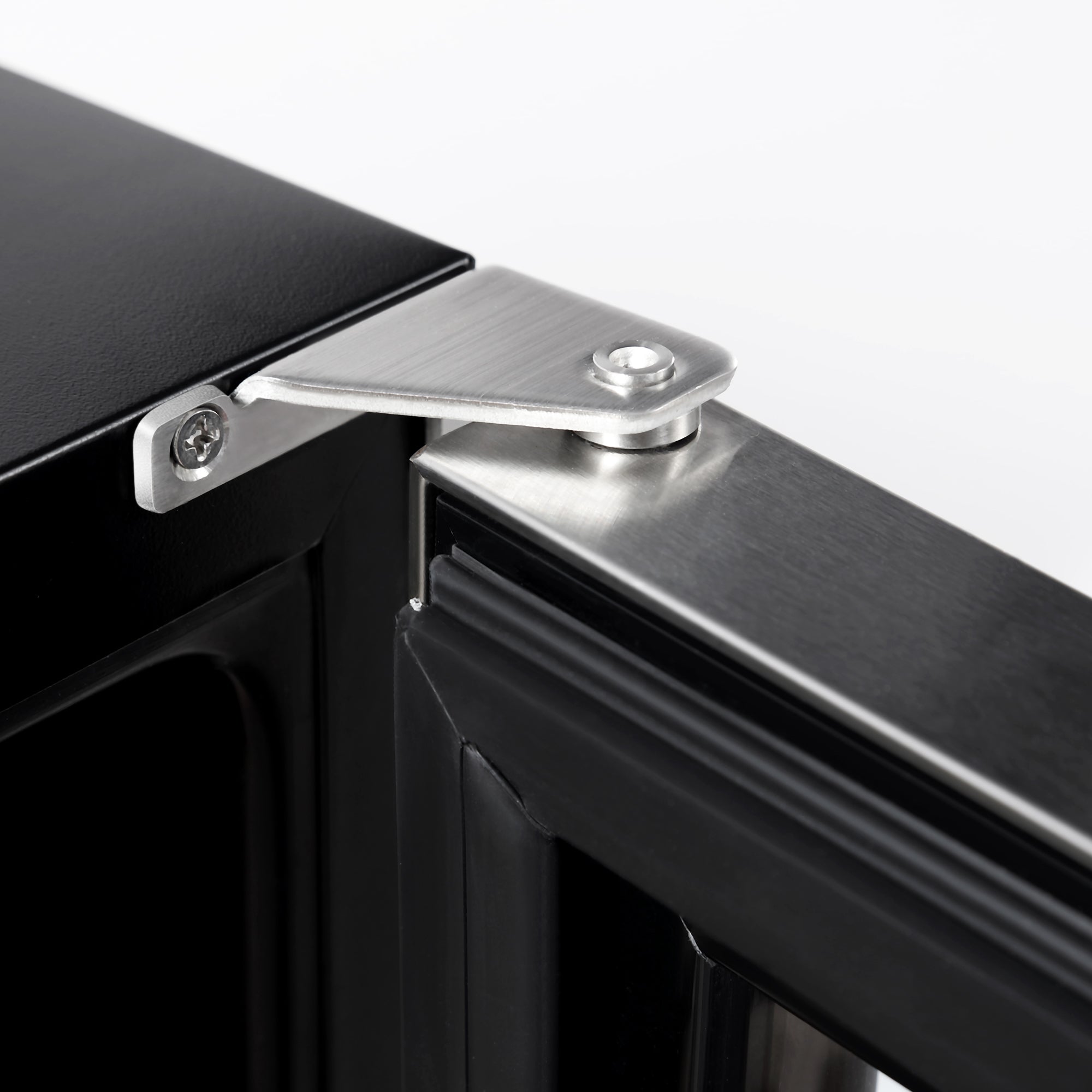 Close-up of a metal hinge on an Empava 24 Inch Fridge Dual Zone Wine & Beverage Cooler black refrigerator door. The stainless steel hinge is securely attached with screws, allowing the door to open efficiently. The sleek design showcases the intersection of functionality and modern style.