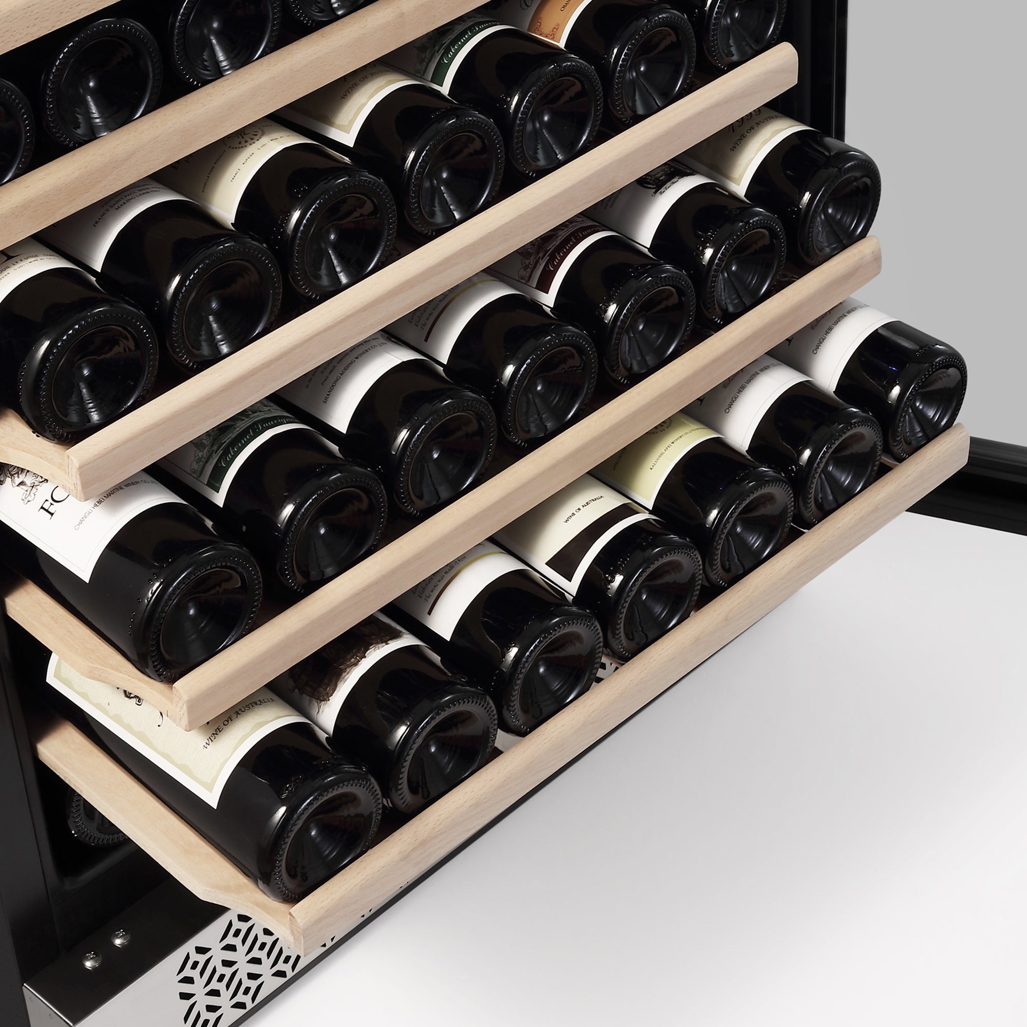 A close-up of the Empava 24 Inch Wine Cooler Wine Fridge 52 Bottles, featuring three wooden shelves, each holding several horizontally-stored wine bottles with their necks facing inward. The partially extended shelves reveal the bottles' labels and caps.