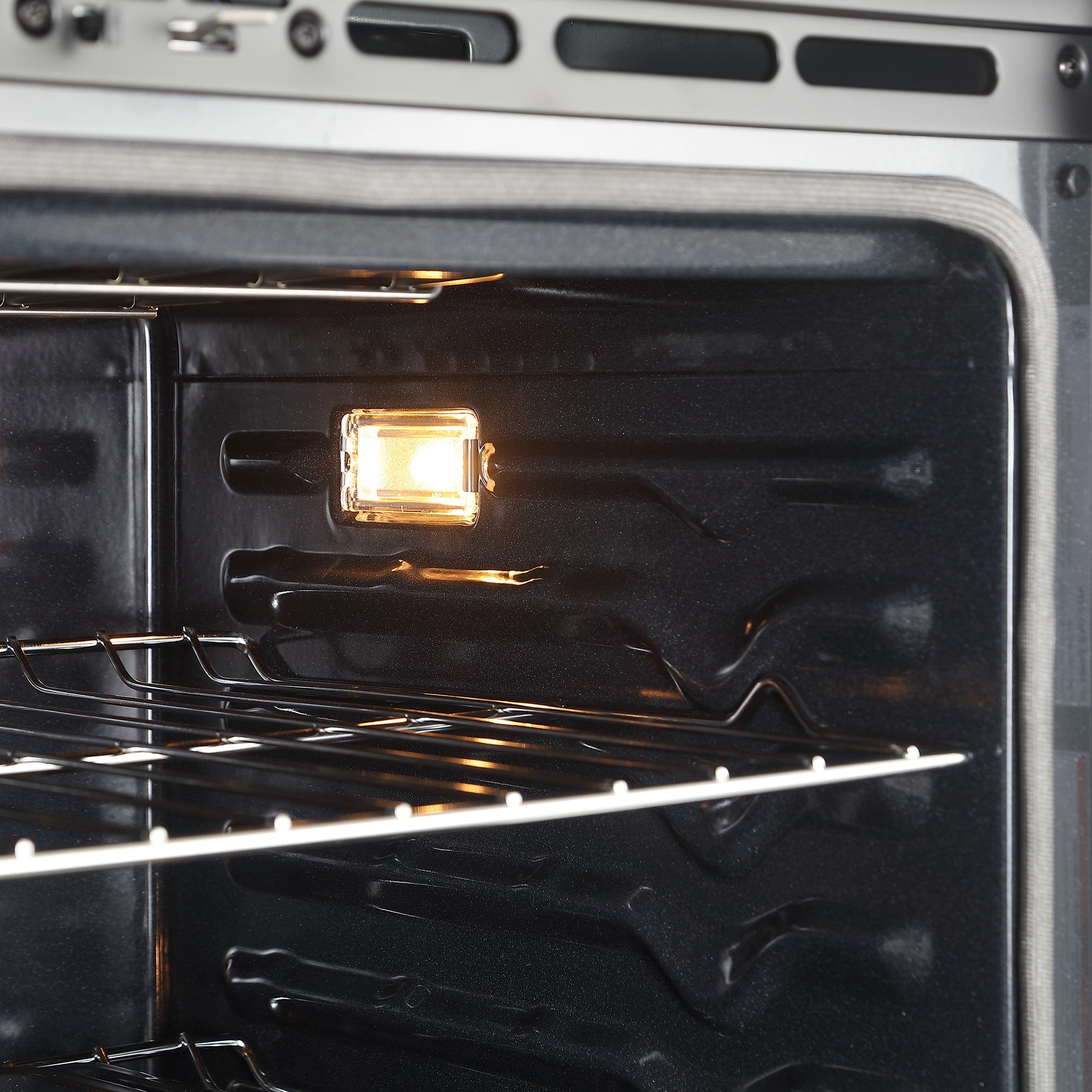 Close-up view of the Empava 30" Electric Single Wall Oven interior with two metal racks and the oven light turned on, illuminating the dark, clean, and empty cavity. The reflective walls highlight the visible heating elements through the 4-layer glass door. This model boasts an air frying function for healthier cooking options.