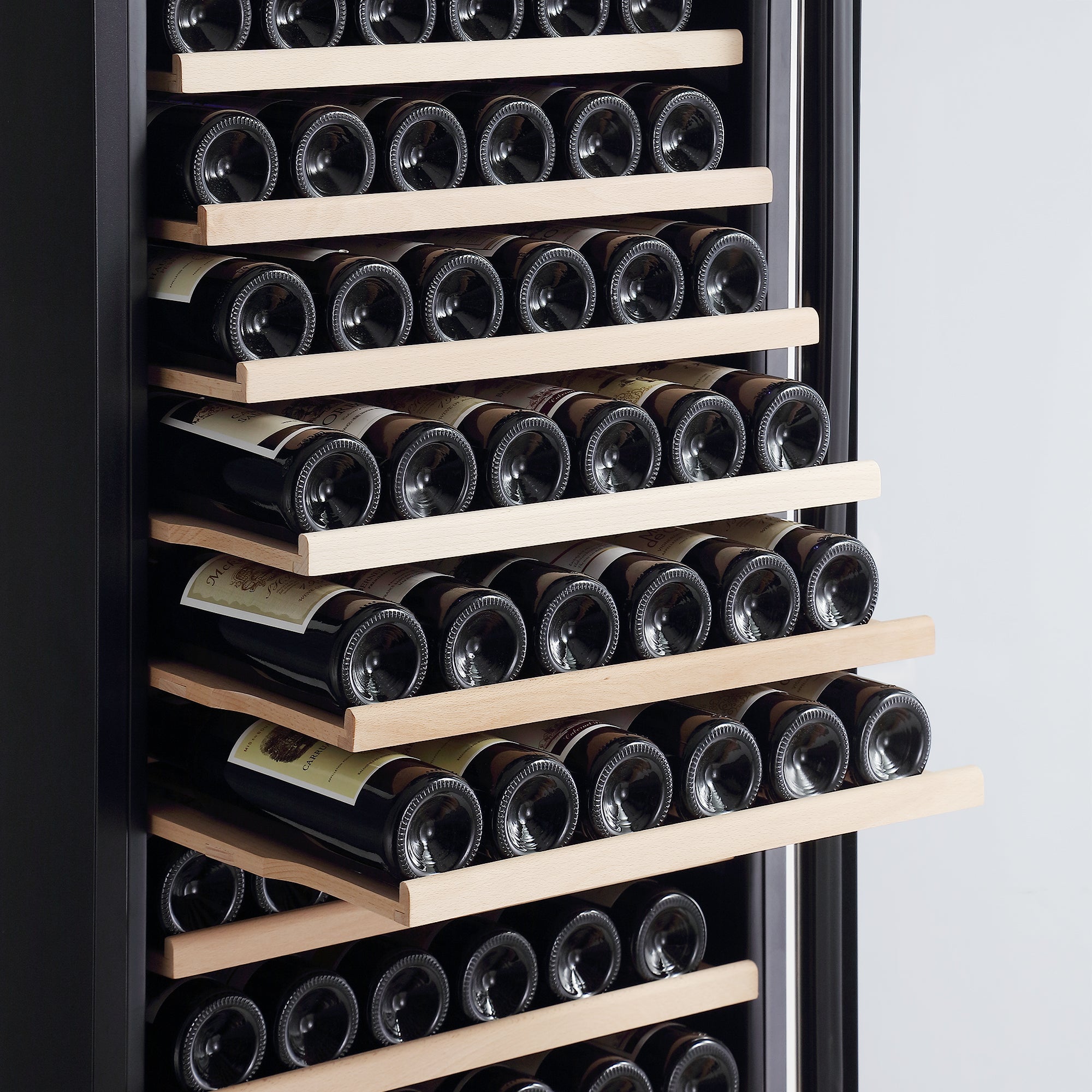 The Empava Wine Cooler 70" Tall Wine Fridge boasts multiple wooden shelves, each holding rows of wine bottles lying horizontally. The cooler's door is slightly open, revealing the neatly organized bottles within. Featuring advanced temperature control and a sleek, modern design, it offers an enormous capacity for your collection.