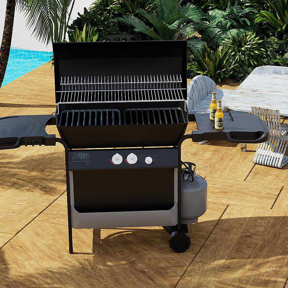 A black outdoor gas grill with its lid open stands on a wooden patio near a pool, connected to an Empava 5 Feet Propane Adapter Hose 1 lb to 20 lb with Upgraded Gauge EMPV-50EH47. The grill, which features three knobs and side shelves holding condiments and beverages, is surrounded by lush greenery. A white chair and table can be seen in the background.