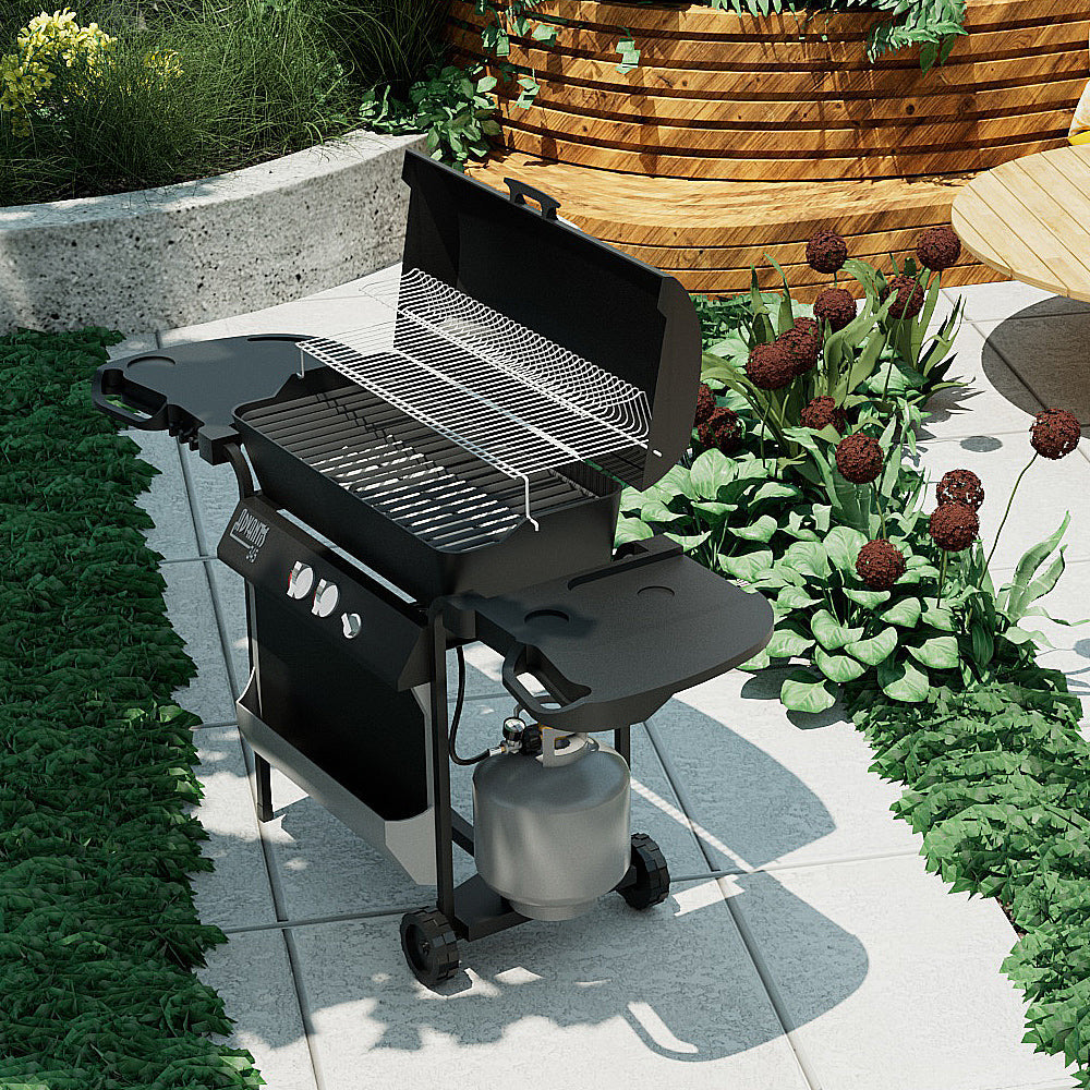 An Empava 5 Feet Propane Adapter Hose 1 lb to 20 lb with Upgraded Gauge EMPV-50EH47 is attached to a black gas grill with its lid open, revealing the grilling racks inside. The grill is positioned on a tiled patio, surrounded by green leafy plants and red flowers. An adjacent wooden bench is partially visible in the scene.