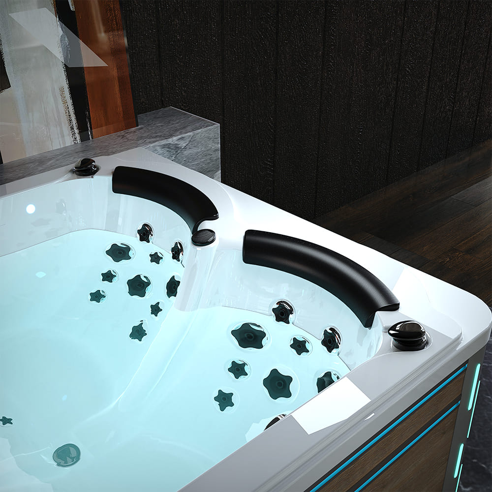 A close-up view of the Empava 75 in. Freestanding Luxury Thermostatic 2-Person Rectangle LED Tub with Right Drain, showcasing its ergonomic headrests, numerous hydrotherapy jets, and ambient blue lighting. The clear water is enhanced by ozone disinfection, and the surrounding area features part of a wooden wall and a marble-tiled surface.