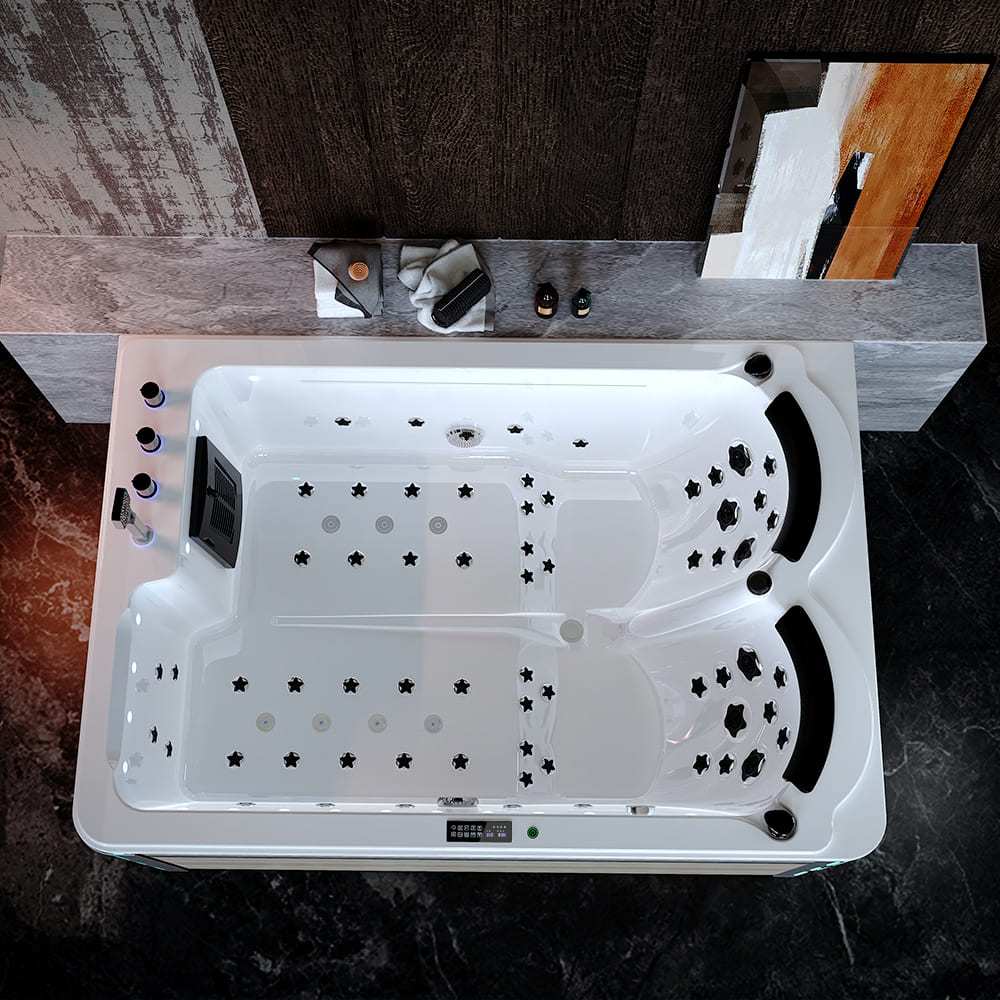 An overhead view of the Empava 75 in. Freestanding Luxury Thermostatic 2-Person Rectangle LED Tub With Right Drain showcases a modern, illuminated spa bathtub featuring ergonomic seating for two, black cushioned headrests, and numerous jets. This pet-friendly massage tub is set against a dark, stylish wall with various bath accessories placed on the surrounding ledge.