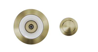 Two Custom Nozzle Color drains with different sizes are shown. The larger drain has a central hole with a white ring around it, while the smaller drain features a completely brass surface with a slotted design. The background is plain white.