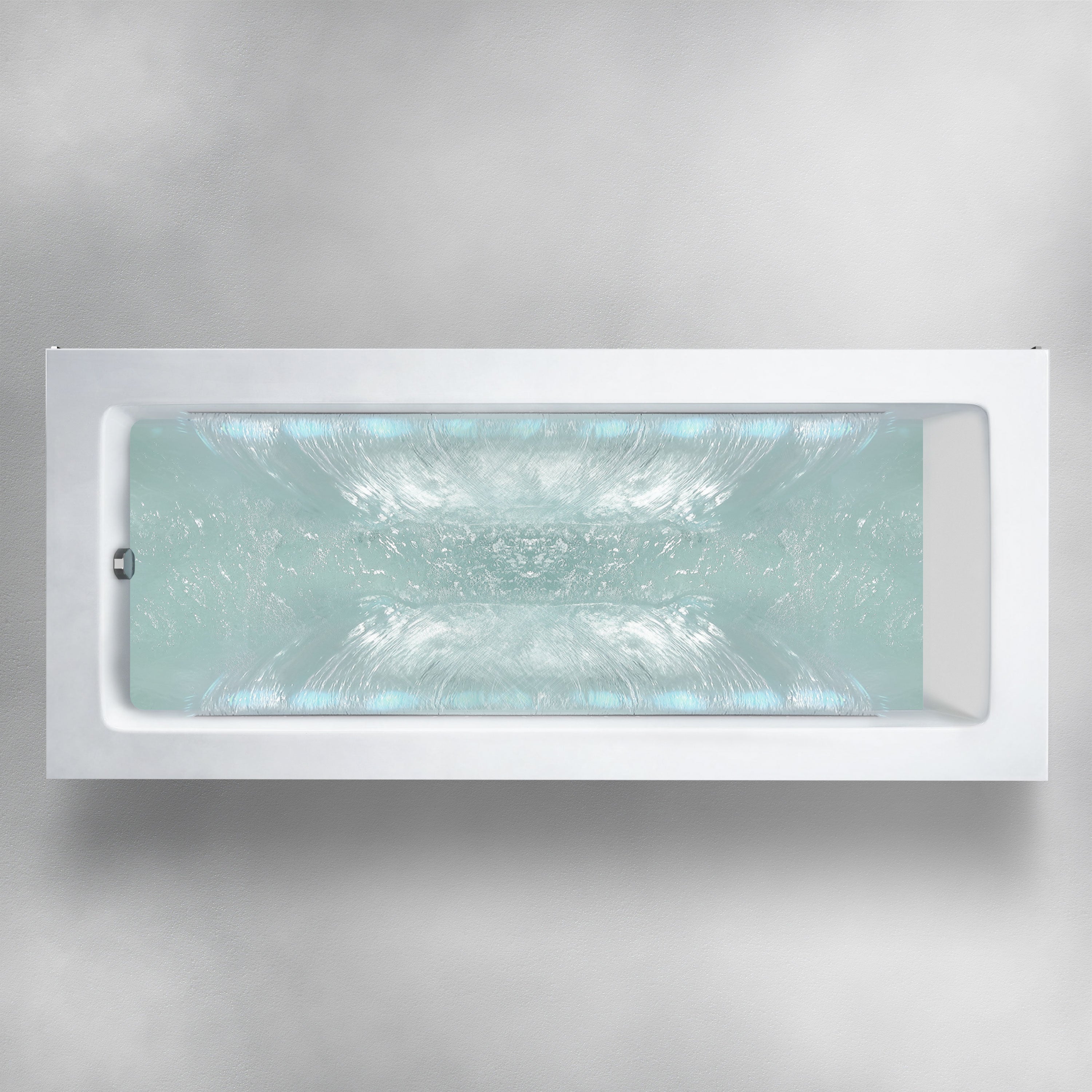 A Custom Function bathtub with churning, clear blue water is set against a pale gray background. The image, taken from an overhead perspective, showcases the turbulent water within the bathtub.