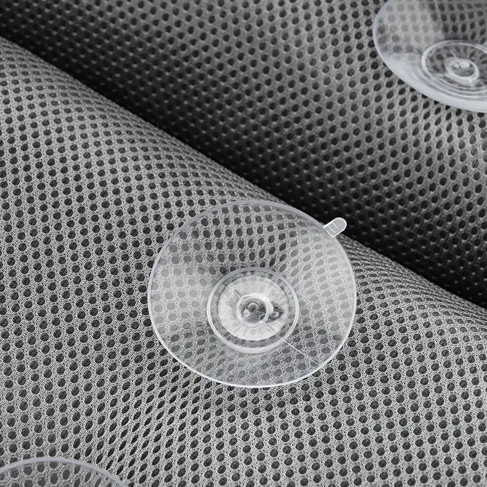 A detailed image showcasing the Soft Bathtub Pillow for Whirlpool Spa Tubs, highlighting its gray, perforated mesh-like material adorned with several transparent suction cups. The focus is on the intricate texture of the pillow and the clear visibility of the suction cups.