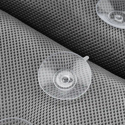 A detailed image showcasing the Soft Bathtub Pillow for Whirlpool Spa Tubs, highlighting its Dark Grey, perforated mesh-like material adorned with several transparent suction cups. The focus is on the intricate texture of the pillow and the clear visibility of the suction cups.
